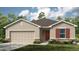 Charming single-story home featuring a two-car garage, neutral stucco exterior, and a well-manicured lawn at 13478 Tropical Breeze Way, Hudson, FL 34669