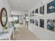Inviting hallway with stylish decor, views of the living and dining areas, and plenty of natural light at 13478 Tropical Breeze Way, Hudson, FL 34669