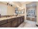 Spacious bathroom with granite countertops, dual sinks, and a luxurious soaking tub at 1509 Amarone Pl, Lutz, FL 33548