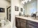 Well-appointed bathroom featuring granite countertops, a shower, and modern fixtures for a luxurious feel at 1509 Amarone Pl, Lutz, FL 33548