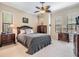 Cozy bedroom with elegant ceiling fan, crown molding, and neutral color palette at 1509 Amarone Pl, Lutz, FL 33548