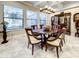 Elegant dining room featuring tile floors, coffered ceilings, and a stylish chandelier at 1509 Amarone Pl, Lutz, FL 33548