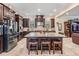 Large kitchen with dark wood cabinets, granite countertops and stainless steel appliances at 1509 Amarone Pl, Lutz, FL 33548