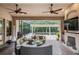 Inviting lanai boasts stylish seating, fireplace, and a view of the pool and pergola at 1509 Amarone Pl, Lutz, FL 33548