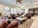 Spacious living room with tile floors, large windows, and an open layout at 1509 Amarone Pl, Lutz, FL 33548