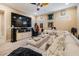 Comfortable living room featuring a large sectional sofa and entertainment center at 1509 Amarone Pl, Lutz, FL 33548