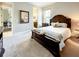 Comfortable main bedroom featuring a large bed, soft carpet, and ensuite bathroom access for added convenience at 1509 Amarone Pl, Lutz, FL 33548