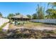 Fenced-in backyard featuring a fire pit and seating area with access to the screened in porch at 15856 49Th N St, Clearwater, FL 33762