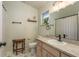 Bathroom with neutral walls, patterned floor, vanity, and modern sink at 15856 49Th N St, Clearwater, FL 33762
