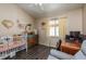 Cozy bedroom featuring wood floors, crib, office space, and eclectic decor at 15856 49Th N St, Clearwater, FL 33762