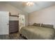 Cozy bedroom with wood flooring, a full size bed, chest of drawers, and neutral wall color at 15856 49Th N St, Clearwater, FL 33762