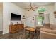 Comfortable living room with vaulted ceiling, wall-mounted TV, and a large window at 15856 49Th N St, Clearwater, FL 33762