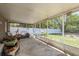 Spacious screened porch featuring a concrete floor and views of the fenced backyard at 15856 49Th N St, Clearwater, FL 33762