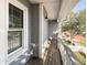 The balcony showcases wooden decking with white railing, complemented by gray siding at 16127 Churchview S Dr, Lithia, FL 33547