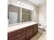 Bright bathroom with large mirror, tiled shower, toilet, and cherry vanity with countertop at 16127 Churchview S Dr, Lithia, FL 33547