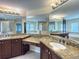 Bathroom with dual sinks, granite countertops, tile floor, soaking tub and stand up shower at 16127 Churchview S Dr, Lithia, FL 33547