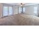 Large bedroom with french doors, carpeting, ceiling fan and light, and ample natural light at 16127 Churchview S Dr, Lithia, FL 33547