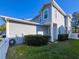 Exterior side view of a two-story home, showcasing a well-kept lawn and white picket fence at 16127 Churchview S Dr, Lithia, FL 33547