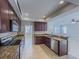 Open kitchen with stainless steel appliances, granite countertops, and breakfast bar at 16127 Churchview S Dr, Lithia, FL 33547