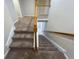 Carpeted stairway with oak handrail at 16127 Churchview S Dr, Lithia, FL 33547