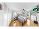 Comfortable bedroom with hardwood floors, ceiling fan, and bright natural light at 1613 E Del Webb Blvd, Sun City Center, FL 33573