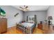 Cozy bedroom featuring hardwood floors, ceiling fan, and a large window at 1613 E Del Webb Blvd, Sun City Center, FL 33573
