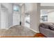 Bright foyer leading to kitchen with tile floor and high ceiling at 1613 E Del Webb Blvd, Sun City Center, FL 33573
