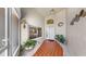 Inviting front entrance featuring a tiled porch, decorative plants, and a glimpse into the bright kitchen through the window at 1613 E Del Webb Blvd, Sun City Center, FL 33573