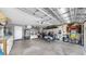 Spacious garage featuring a laundry area, a golf cart, and ample storage space at 1613 E Del Webb Blvd, Sun City Center, FL 33573