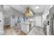 Bright kitchen with granite countertops, stainless steel appliances, tile floor, and island at 1613 E Del Webb Blvd, Sun City Center, FL 33573