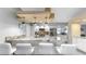 Modern kitchen featuring granite countertops, stainless steel appliances, pendant lighting, and ample counter space at 1613 E Del Webb Blvd, Sun City Center, FL 33573