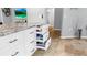 Spacious kitchen featuring custom drawers with granite countertops, tile flooring, and access to other rooms in the house at 1613 E Del Webb Blvd, Sun City Center, FL 33573