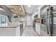 Bright kitchen with granite countertops, stainless steel appliances, and white cabinetry, creating a modern cooking space at 1613 E Del Webb Blvd, Sun City Center, FL 33573