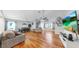 Bright living room with hardwood floors, ceiling fans, and a comfortable seating area at 1613 E Del Webb Blvd, Sun City Center, FL 33573