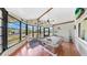 Bright sun room featuring a pool table, tile floors, and large windows offering views of the lush surrounding landscape at 1613 E Del Webb Blvd, Sun City Center, FL 33573