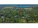 Wooded acreage featuring hidden homes and a lake in the background for a private setting at 16420 Iola Woods Trl, Dade City, FL 33523