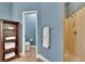 Bathroom with tile floor, a walk-in shower, a toilet, and a towel rack at 16420 Iola Woods Trl, Dade City, FL 33523