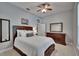 Cozy bedroom featuring carpet, dresser and two mirrors at 16420 Iola Woods Trl, Dade City, FL 33523