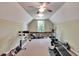 This home's gym features an exercise bike, rower, weight bench, and plush carpet floors at 16420 Iola Woods Trl, Dade City, FL 33523