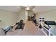 This home's gym includes free weights, elliptical machine, and a weight bench at 16420 Iola Woods Trl, Dade City, FL 33523