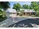 Charming white home with metal roof, detached garage, and manicured lawn at 16420 Iola Woods Trl, Dade City, FL 33523