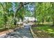 Inviting two-story home with metal roof and lush landscaping at 16420 Iola Woods Trl, Dade City, FL 33523
