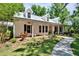 Charming home with metal roof, covered front porch, and rocking chairs at 16420 Iola Woods Trl, Dade City, FL 33523