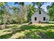 Exterior view of home on large lot featuring pristine landscaping and access to fenced side-yard at 16420 Iola Woods Trl, Dade City, FL 33523