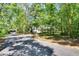 View of the home and driveway in a lush, private setting at 16420 Iola Woods Trl, Dade City, FL 33523