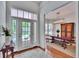 Welcoming foyer with view of the dining area and features a bright entryway with glass-paneled doors at 16420 Iola Woods Trl, Dade City, FL 33523