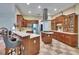 Well-appointed kitchen featuring a central island, modern range hood, and sleek stainless steel appliances at 16420 Iola Woods Trl, Dade City, FL 33523