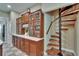 Kitchen area featuring a built-in china cabinet and access to a unique spiral staircase at 16420 Iola Woods Trl, Dade City, FL 33523