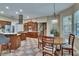 Eat-in kitchen featuring checkered tile floor, stainless steel appliances, and adjacent staircase at 16420 Iola Woods Trl, Dade City, FL 33523