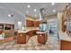 Open-concept kitchen features a center island, stainless steel appliances, and a seamless flow to the living spaces at 16420 Iola Woods Trl, Dade City, FL 33523